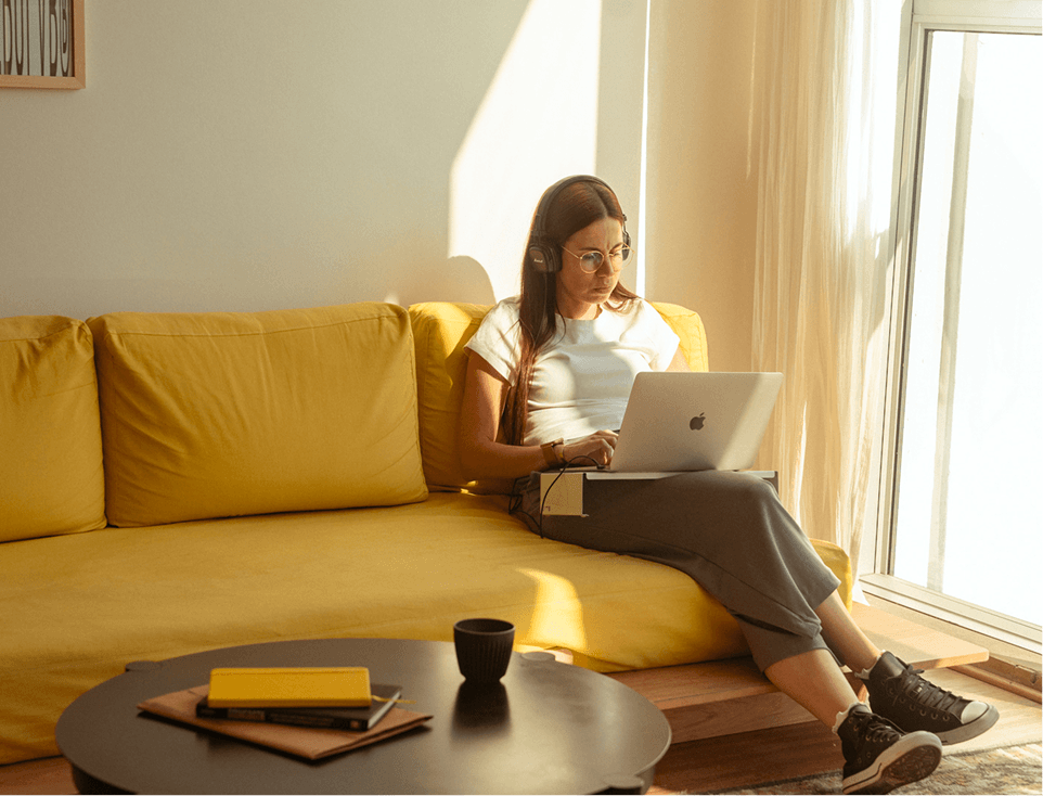 Person sitting in the coach with a laptop